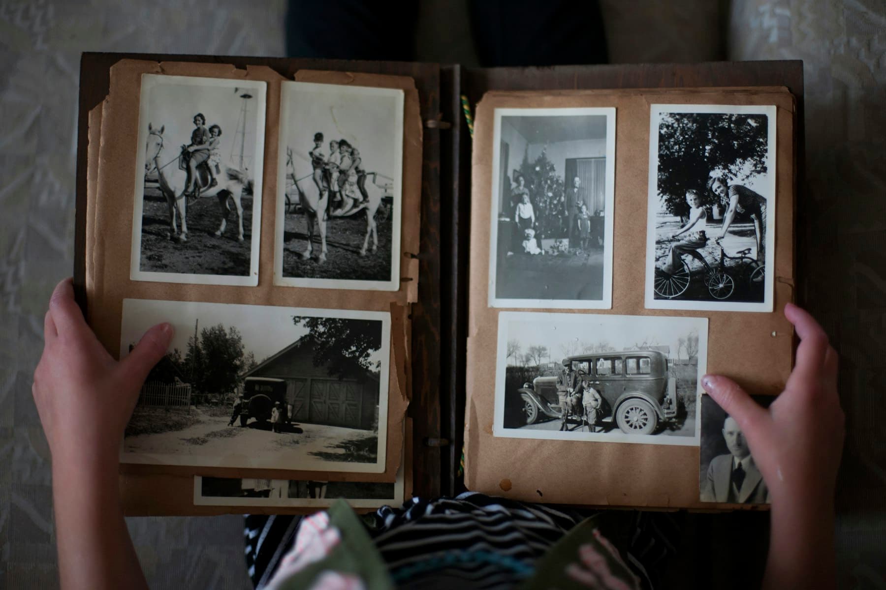 Hands turning the pages of a printed album