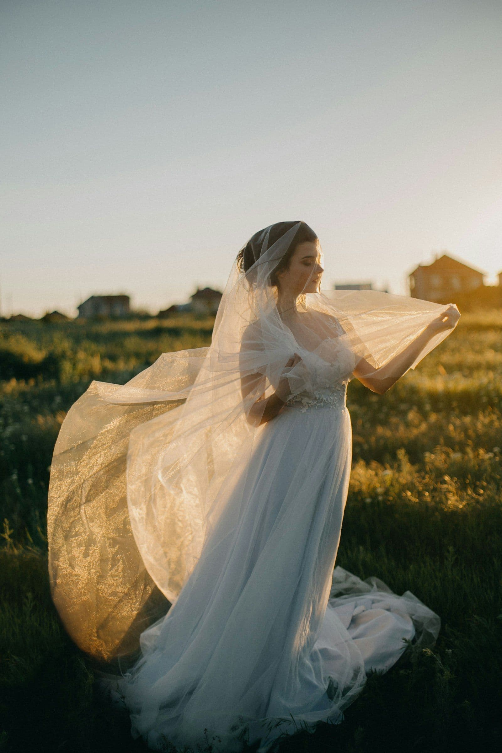 Leila's veil caught in the sea wind at golden hour
