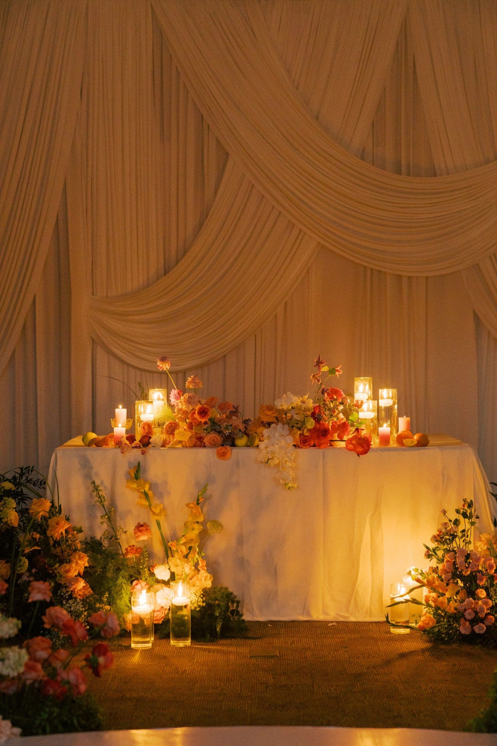 The dinner table dressed in candlelight and autumn flowers
